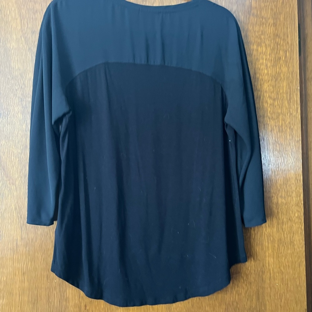 Black Tahari soft jersey, like material with see-through mesh at the upper chest